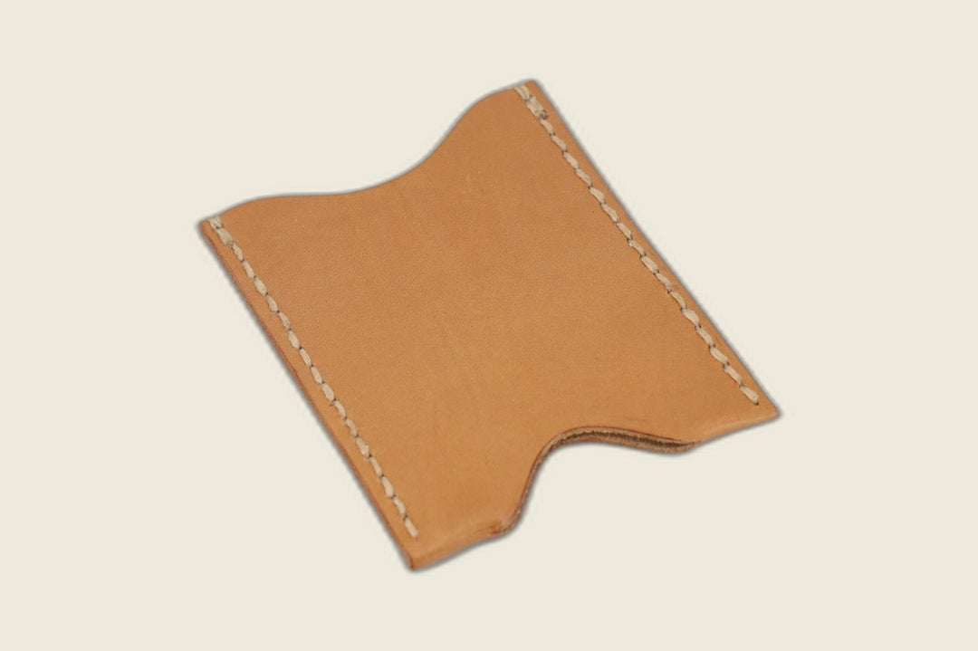 Reverse of the Safeguard natural calfskin sleeve showing its notched edge and hand stitching on tan leather