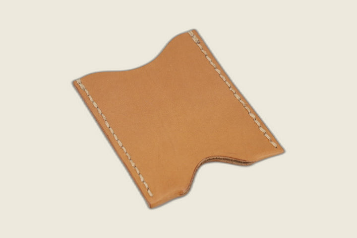 Reverse of the Safeguard natural calfskin sleeve showing its notched edge and hand stitching on tan leather