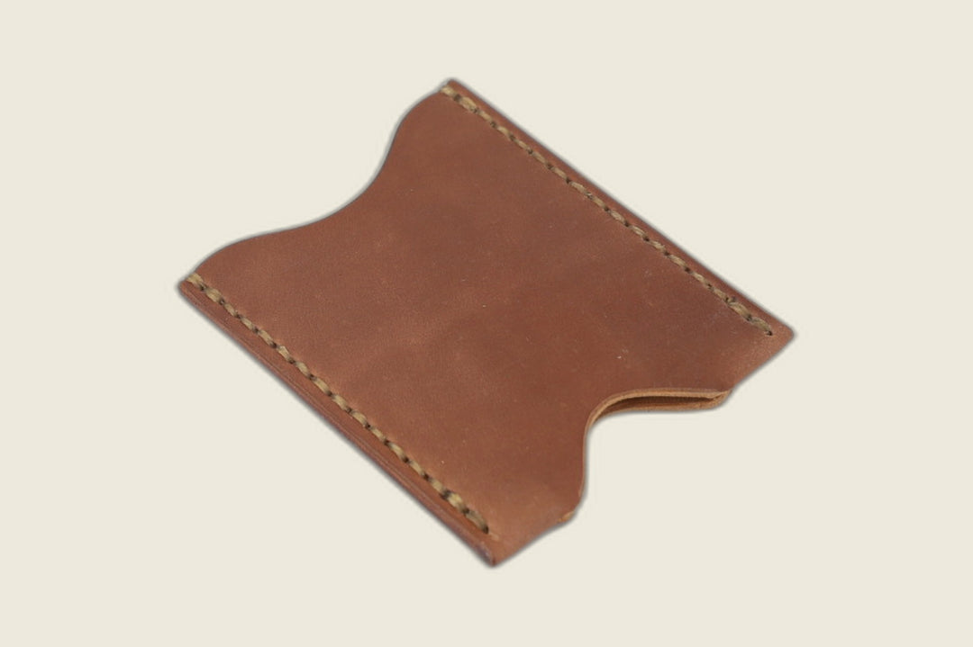 Second angle of the Sentinel unglazed natural shell cordovan sleeve, thumb notch and warm patina visible