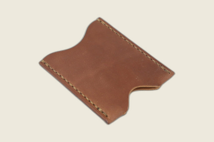 Second angle of the Sentinel unglazed natural shell cordovan sleeve, thumb notch and warm patina visible